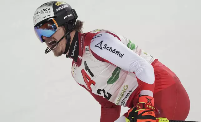 Austria's Manuel Feller celebrates at the finish area of an alpine ski, men's World Cup slalom, in Schladming, Austria, Wednesday, Jan. 29, 2025. (AP Photo/Giovanni Auletta)