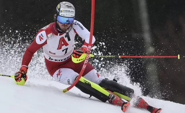 Austria's Manuel Feller speeds down the course during an alpine ski, men's World Cup slalom, in Kitzbühel, Austria, Sunday, Jan. 26, 2025. (AP Photo/Marco Trovati)