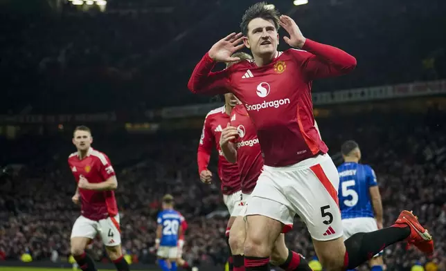 Manchester United's Harry Maguire celebrates after scoring his side's third goal during the English Premier League soccer match between Manchester United and Ipswich Town at the Old Trafford stadium in Manchester, England, Wednesday, Feb. 26, 2025. (AP Photo/Dave Thompson)
