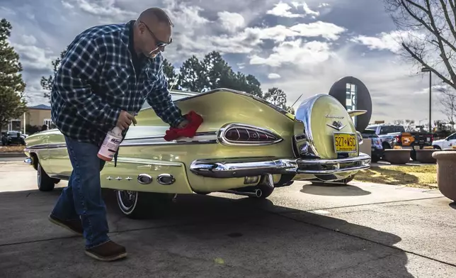 Joe Romero of Albuquerque shines his original 1959 Chevy Impala outside the State Capitol in Santa Fe, N.M. on Low Rider day, Tuesday, Feb. 11, 2025. (AP Photo/Roberto E. Rosales)