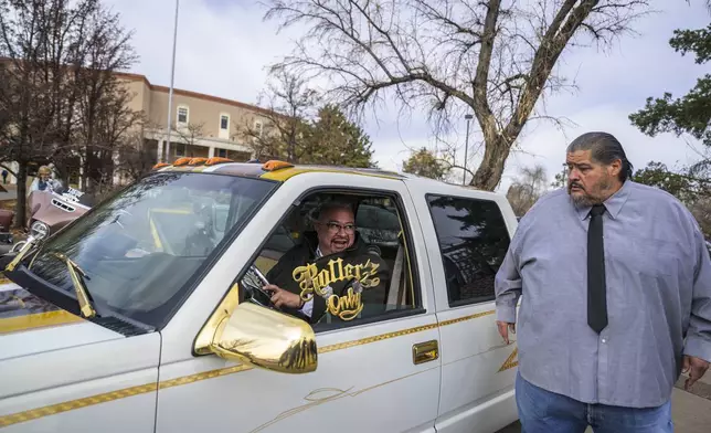 New Mexico State Senator Leo Jaramillo of Espanola sits inside a lowrider truck owned by Lorenzo Otero outside of the State Capitol in Santa Fe, N.M., on Lowrider Day, Tuesday, Feb. 11, 2025. (AP Photo/Roberto E. Rosales)