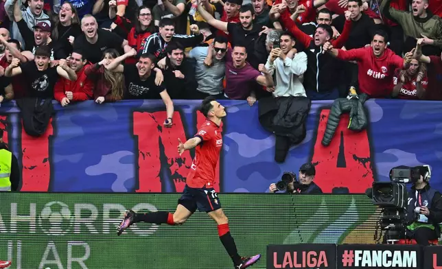 Osasuna's Ante Budimir celebrates after scoring his side's first goal during a Spanish La Liga soccer match between Osasuna and Real Madrid at El Sardar stadium in Pamplona, Spain, Saturday, Feb. 15, 2025. (AP Photo/Miguel Oses)