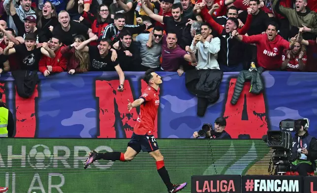 Osasuna's Ante Budimir celebrates after scoring his side's first goal during a Spanish La Liga soccer match between Osasuna and Real Madrid at El Sardar stadium in Pamplona, Spain, Saturday, Feb. 15, 2025. (AP Photo/Miguel Oses)