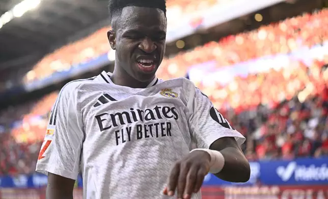 Real Madrid's Vinicius Junior reacts during a Spanish La Liga soccer match between Osasuna and Real Madrid at El Sardar stadium in Pamplona, Spain, Saturday, Feb. 15, 2025. (AP Photo/Miguel Oses)