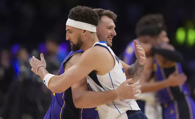 Los Angeles Lakers guard Luka Doncic, left, and Dallas Mavericks guard Klay Thompson hug before an NBA basketball game Tuesday, Feb. 25, 2025, in Los Angeles. (AP Photo/Mark J. Terrill)