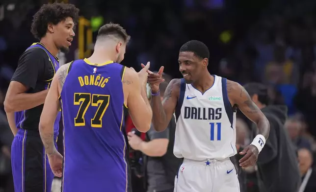 Los Angeles Lakers guard Luka Doncic (77) and Dallas Mavericks guard Kyrie Irving (11) shake hands before an NBA basketball game Tuesday, Feb. 25, 2025, in Los Angeles. (AP Photo/Mark J. Terrill)