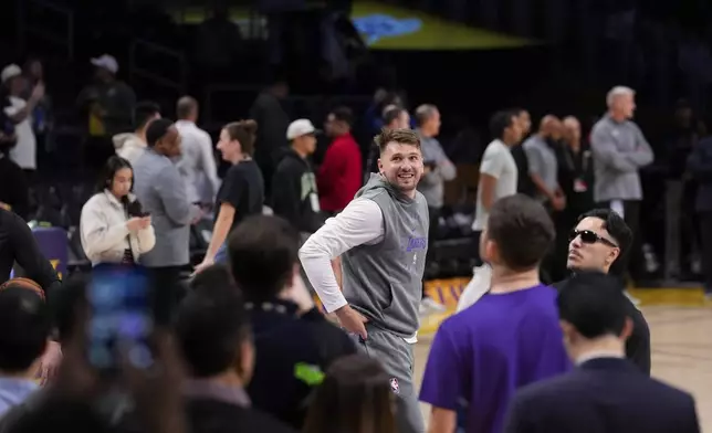Los Angeles Lakers guard Luka Doncic, center, warms up before an NBA basketball game against the Dallas Mavericks, Tuesday, Feb. 25, 2025, in Los Angeles. (AP Photo/Mark J. Terrill)