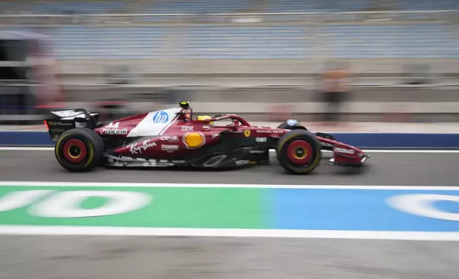 Ferrari driver Lewis Hamilton of Britain drives through the pit lane during a Formula One pre-season test at the Bahrain International Circuit in Sakhir, Bahrain, Thursday, Feb. 27, 2025. (AP Photo/Darko Bandic)