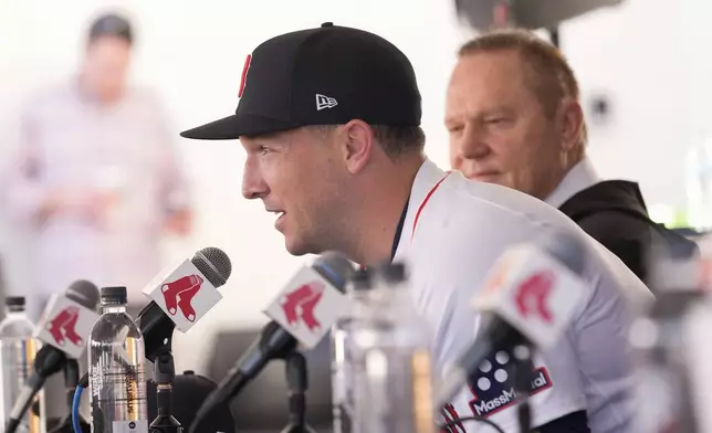 Alex Bregman speaks at a news conference after he signed a three year contract with the Boston Red Sox in Fort Myers, Fla., Sunday, Feb. 16, 2025. Behind is agent Scott Boras. (AP Photo/Gerald Herbert)