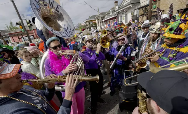 FILE - The Krewe du Belge plays during the Society of Saint Anne parade through Bywater and Marigny neighborhoods on Mardi Gras Day in New Orleans, Feb. 13, 2024. (AP Photo/Matthew Hinton, File)