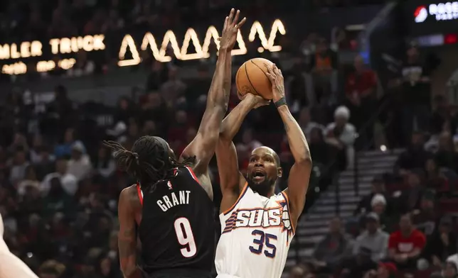 Phoenix Suns forward Kevin Durant (35) shoots over Portland Trail Blazers forward Jerami Grant (9) during the second half of an NBA basketball game Saturday, Feb. 1, 2025, in Portland, Ore. (AP Photo/Amanda Loman)