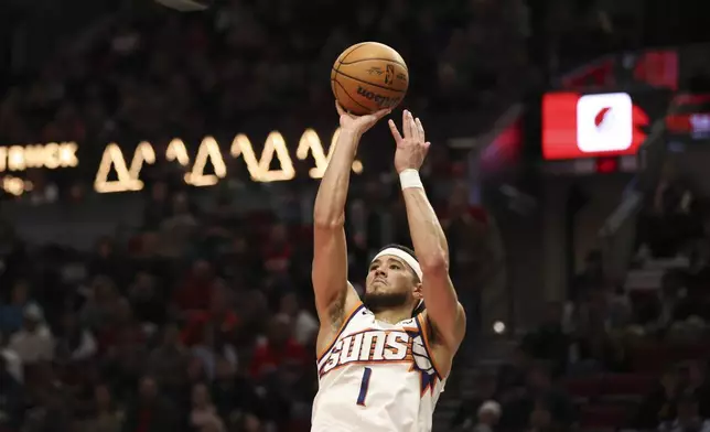 Phoenix Suns guard Devin Booker (1) shoots against the Portland Trail Blazers during the second half of an NBA basketball game Saturday, Feb. 1, 2025, in Portland, Ore. (AP Photo/Amanda Loman)