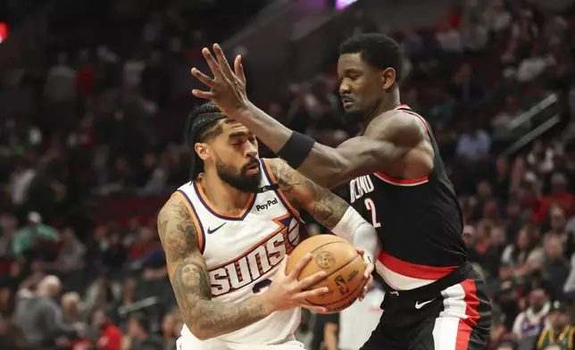 Phoenix Suns center Nick Richards, left, drives to the basket as Portland Trail Blazers center Deandre Ayton, right, defends during the second half of an NBA basketball game Saturday, Feb. 1, 2025, in Portland, Ore. (AP Photo/Amanda Loman)