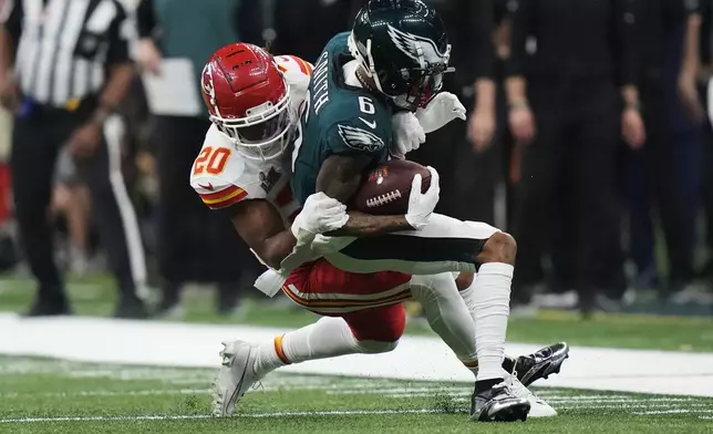 Philadelphia Eagles wide receiver DeVonta Smith (6) is hit by Kansas City Chiefs safety Justin Reid (20) during the second half of the NFL Super Bowl 59 football game, Sunday, Feb. 9, 2025, in New Orleans. (AP Photo/Frank Franklin II)