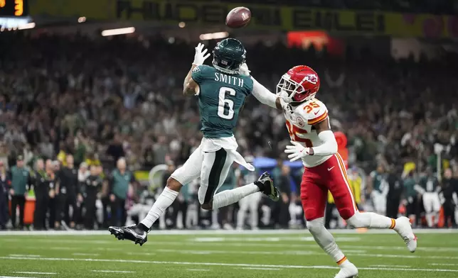 Philadelphia Eagles wide receiver DeVonta Smith (6) makes a touchdown catch past Kansas City Chiefs cornerback Jaylen Watson (35) during the second half of the NFL Super Bowl 59 football game, Sunday, Feb. 9, 2025, in New Orleans. (AP Photo/Abbie Parr)
