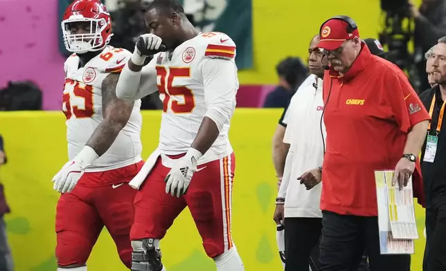 Kansas City Chiefs defensive tackle Chris Jones (95) walks off the field after an injury followed by head coach Andy Reid during the second half of the NFL Super Bowl 59 football game against the Philadelphia Eagles, Sunday, Feb. 9, 2025, in New Orleans. (AP Photo/Ashley Landis)