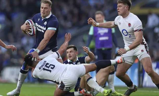 Scotland's Duhan van der Merwe, left, holds off England's Marcus Smith during the Six Nations rugby union match between England and Scotland at Twickenham in London, Saturday, Feb. 22, 2025. (AP Photo/Ian Walton)