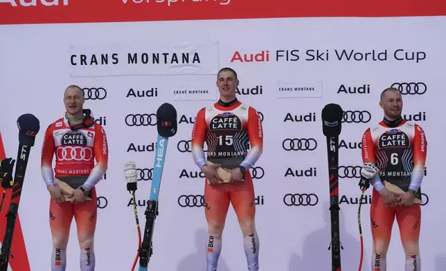 From left, second placed Switzerland's Marco Odermatt, the winner Switzerland's Franjo von Allmen and third placed Switzerland's Alexis Monney celebrate after an alpine ski, men's World Cup downhill, in Crans Montana, Switzerland, Saturday, Feb. 22, 2025. (AP Photo/Giovanni Auletta)