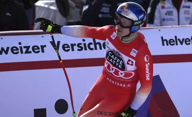 Switzerland's Marco Odermatt reacts after completing an alpine ski, men's World Cup downhill, in Crans Montana, Switzerland, Saturday, Feb. 22, 2025. (AP Photo/Giovanni Auletta)