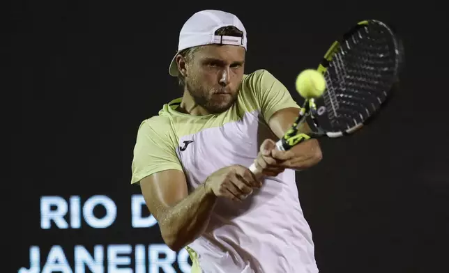 France's Alexandre Muller returns the ball to Brazil's Joao Fonseca during a match at the Rio Open tennis tournament in Rio de Janeiro, Tuesday, Feb. 18, 2025. (AP Photo/Bruna Prado)
