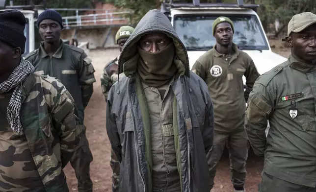 Members of the Lion Intervention Brigade stand at attention at Niokolo Koba National Park, Senegal on Tuesday, Jan. 14, 2025. (AP Photo/Annika Hammerschlag)