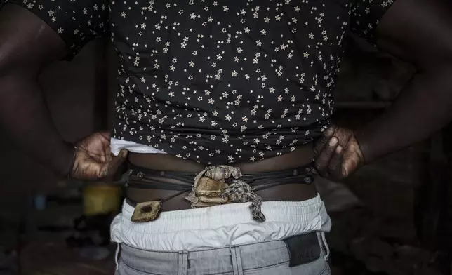 Ibrahim, a fervent believer of Senegalese mysticism, shows off his gris-gris in Tambacounda, Senegal on Thursday, Jan. 16, 2025. His gris-gris are made from animal skins, including lion, which is believed to offer protection and power. (AP Photo/Annika Hammerschlag)