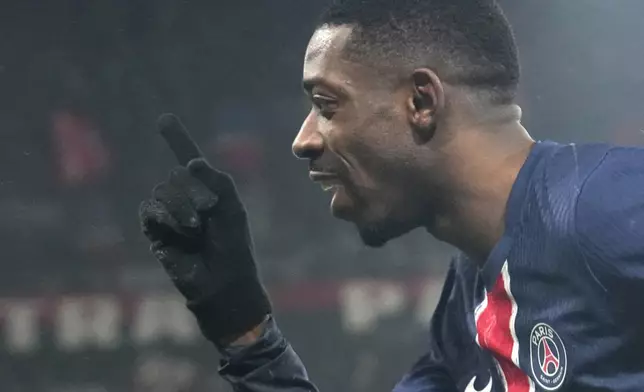 PSG's Ousmane Dembele celebrates after scoring his sides third goal during the French League One soccer match between Paris Saint-Germain and Monaco at Parc des Princes stadium in Paris, Friday, Feb. 7, 2025. (AP Photo/Michel Euler)