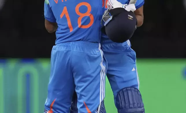 India's Virat Kohli, left, and Axar Patel celebrate after winning against Pakistan during the ICC Champions Trophy cricket match between India and Pakistan at Dubai International Cricket Stadium, United Arab Emirates, Sunday, Feb. 23, 2025. (AP Photo/Altaf Qadri)