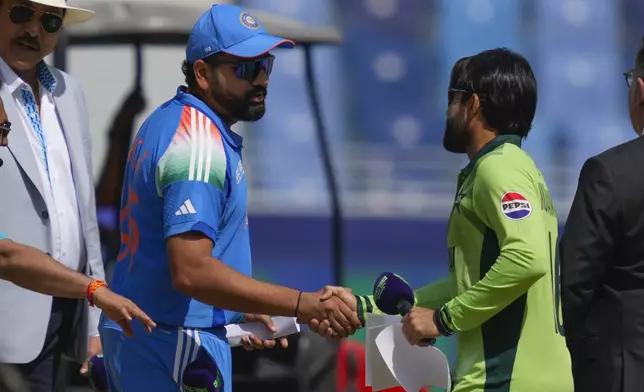 India's captain Rohit Sharma, left, shakes hand with his Pakistan's counterpart Mohammad Rizwan before the coin toss for the ICC Champions Trophy cricket match between India and Pakistan at Dubai International Cricket Stadium, United Arab Emirates, Sunday, Feb. 23, 2025. (AP Photo/Altaf Qadri)