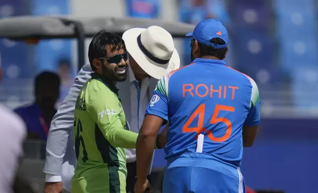 India's captain Rohit Sharma, right, shakes hand with his Pakistan's counterpart Mohammad Rizwan after the coin toss for the ICC Champions Trophy cricket match between India and Pakistan at Dubai International Cricket Stadium, United Arab Emirates, Sunday, Feb. 23, 2025. (AP Photo/Altaf Qadri)