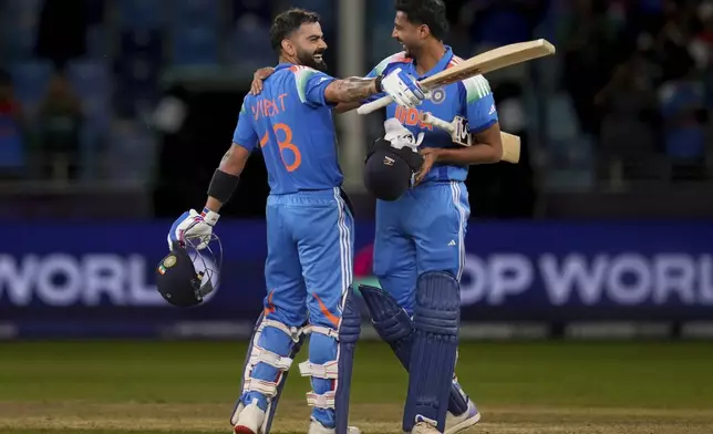 India's Virat Kohli, left, and Axar Patel celebrate after winning against Pakistan during the ICC Champions Trophy cricket match between India and Pakistan at Dubai International Cricket Stadium, United Arab Emirates, Sunday, Feb. 23, 2025. (AP Photo/Altaf Qadri)