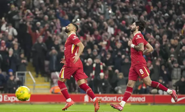 Liverpool's Mohamed Salah, left, celebrates with Dominik Szoboszlai after scoring the second goal from the penalty spot during the English League Cup semifinal second leg soccer match between Liverpool and Tottenham Hotspur at Anfield Stadium in Liverpool, England, Thursday, Feb. 6, 2025. (AP Photo/Jon Super)