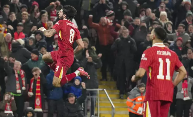 Liverpool's Dominik Szoboszlai celebrates scoring his side's third goal during the English League Cup semifinal second leg soccer match between Liverpool and Tottenham Hotspur at Anfield Stadium in Liverpool, England, Thursday, Feb. 6, 2025. (AP Photo/Jon Super)
