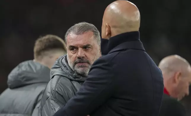 Tottenham's head coach Ange Postecoglou, center, and Liverpool's manager Arne Slot greet each other before the English League Cup semifinal second leg soccer match between Liverpool and Tottenham Hotspur at Anfield Stadium in Liverpool, England, Thursday, Feb. 6, 2025. (AP Photo/Jon Super)