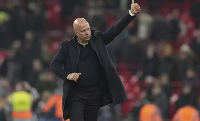 Liverpool's manager Arne Slot greets the crowd after winning the English League Cup semifinal second leg soccer match between Liverpool and Tottenham Hotspur at Anfield Stadium in Liverpool, England, Thursday, Feb. 6, 2025. (AP Photo/Jon Super)
