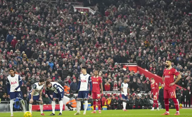 Liverpool's Mohamed Salah, right, prepares to score the second goal from the penalty spot during the English League Cup semifinal second leg soccer match between Liverpool and Tottenham Hotspur at Anfield Stadium in Liverpool, England, Thursday, Feb. 6, 2025. (AP Photo/Jon Super)