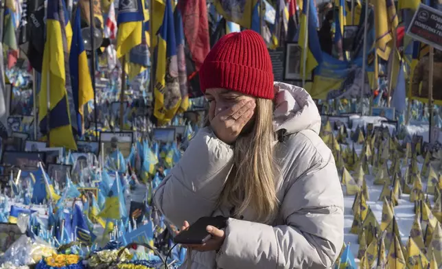 A woman cries at the memorial to the fallen Ukrainian soldiers on Independence Square in Kyiv, Ukraine, Monday, Feb. 24, 2025. (AP Photo/Efrem Lukatsky)