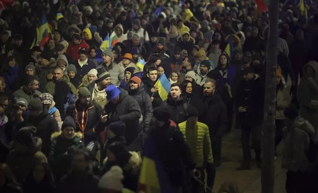 People take part in a march "Stand with Ukraine" as Bulgarians and Ukrainian refugees express their solidarity with Ukrainians who have fought for their freedom for three years since the start of the Russian invasion, Sofia, Monday, Feb. 24, 2025. (AP Photo/Valentina Petrova)