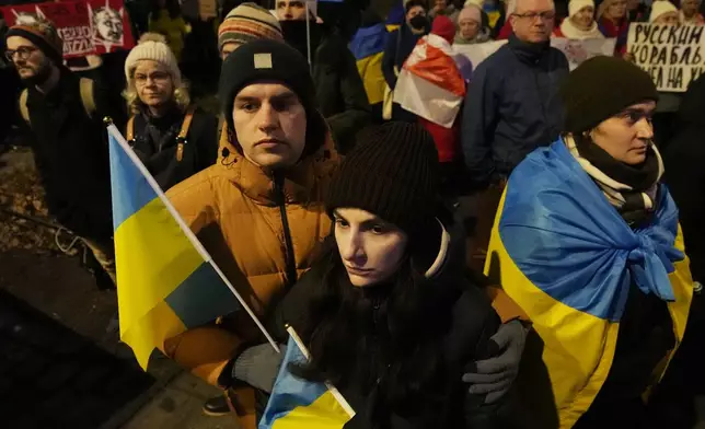 Ukrainian and Polish anti-war activists of the Euromaidan-Warsaw group mark the third anniversary of Russia's invasion of Ukraine, in front of the Ukrainian Embassy in Warsaw, Poland, Monday, Feb. 24, 2025. (AP Photo/Czarek Sokolowski)