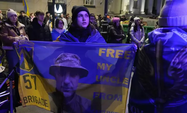 Protesters rallied by Ukrainian and Polish anti-war activists of the Euromaidan-Warsaw group mark the third anniversary of Russia's full-scale war on Ukraine in front of the Ukrainian Embassy in Warsaw, Monday, Feb. 24, 2025. (AP Photo/Czarek Sokolowski)
