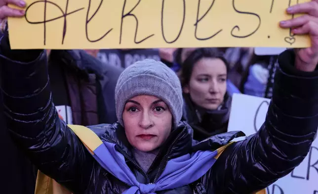A woman holds a sign during a rally in Times Square on the three-year anniversary of Russia's invasion of Ukraine, Monday, Feb. 24, 2025, in New York. (AP Photo/Julia Demaree Nikhinson)