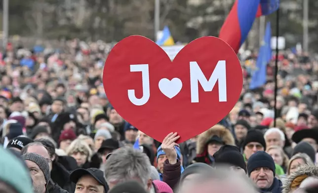 People gather in Bratislava, Slovakia on Friday Feb. 21, 2025, to mark the seventh anniversary of the slayings of an investigative journalist and his fiancee, Jan Kuciak and Martina Kusnirova. (Vaclav Salek/CTK via AP)