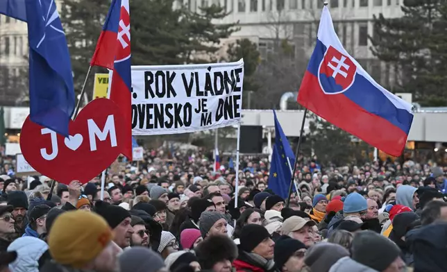 People gather in Bratislava, Slovakia on Friday Feb. 21, 2025, to mark the seventh anniversary of the slayings of an investigative journalist and his fiancee, Jan Kuciak and Martina Kusnirova. (Vaclav Salek/CTK via AP)