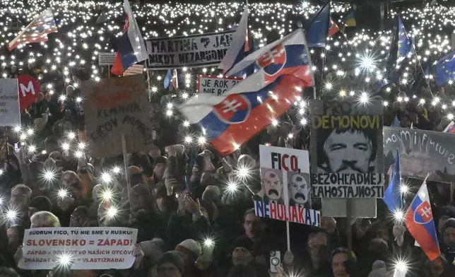 People gather in Bratislava, Slovakia on Friday Feb. 21, 2025, to mark the seventh anniversary of the slayings of an investigative journalist and his fiancee, Jan Kuciak and Martina Kusnirova. (Vaclav Salek/CTK via AP)
