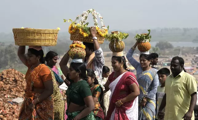 Devotees carry ceremonial offerings on their heads at the Lingamanthula Swamy temple during a Hindu pilgrimage called the Peddagattu Jatara, in Suryapet, Telangana state, India, Tuesday, Feb. 18, 2025. (AP Photo /Mahesh Kumar A.)
