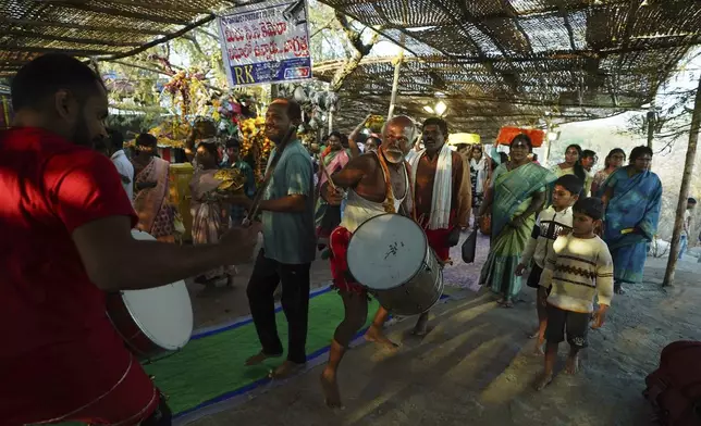 Devotees play drums and dance at the Lingamanthula Swamy temple during a Hindu pilgrimage called the Peddagattu Jatara, in Suryapet, Telangana state, India, Sunday, Feb. 16, 2025. (AP Photo /Mahesh Kumar A.)
