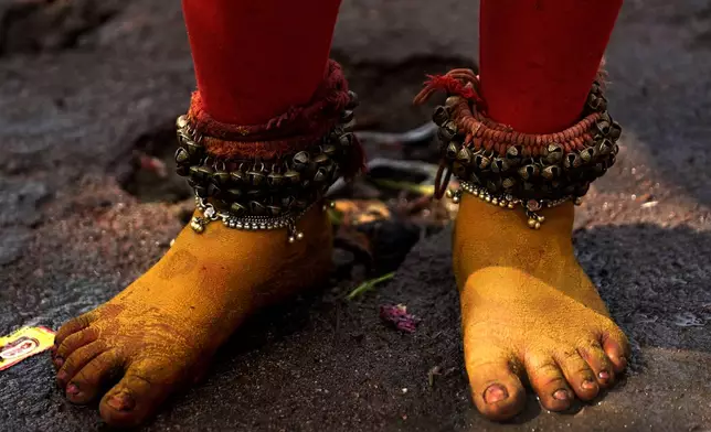 A devotee wears anklets studded with bells as he enacts scenes from Hindu epics at the Lingamanthula Swamy temple during a Hindu pilgrimage called the Peddagattu Jatara, in Suryapet, Telangana state, India, Tuesday, Feb. 18, 2025. (AP Photo /Mahesh Kumar A.)