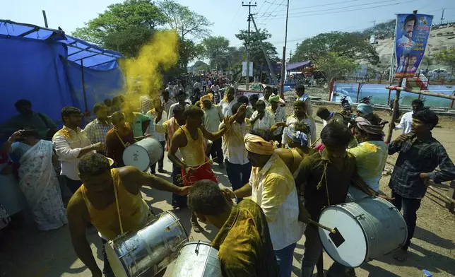 Devotees beat drums and dance at the Lingamanthula Swamy temple during a Hindu pilgrimage called the Peddagattu Jatara, in Suryapet, Telangana state, India, Sunday, Feb. 16, 2025. (AP Photo /Mahesh Kumar A.)