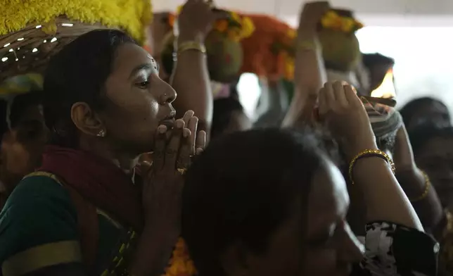 Devotees pray at the Lingamanthula Swamy temple during a Hindu pilgrimage called the Peddagattu Jatara, in Suryapet, Telangana state, India, Sunday, Feb. 16, 2025. (AP Photo /Mahesh Kumar A.)