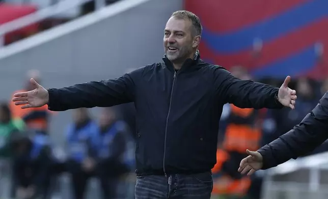 Barcelona's head coach Hansi Flick gestures during a Spanish La Liga soccer match between Barcelona and Alaves at the Lluis Companys Olympic Stadium in Barcelona, Spain, Sunday Feb. 2, 2025. (AP Photo/Joan Monfort)